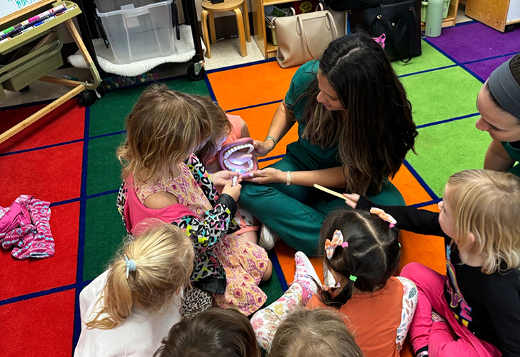 CSD students show elementary students a model of a mouth