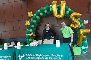 two people standing behind a table