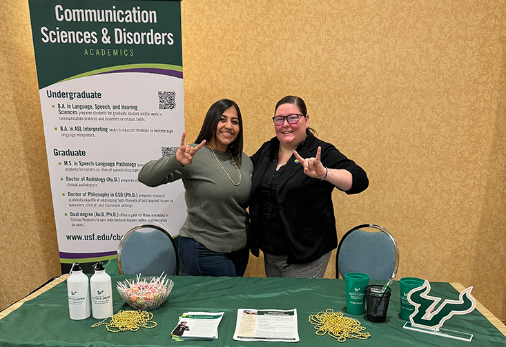 Diane Rifaie, MA, and Samantha Thomas, MA, stand at their booth at the conference in Orlando