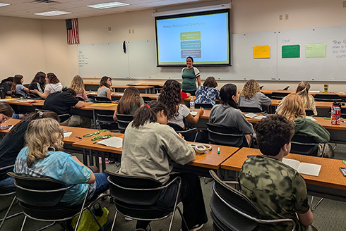 Cary Hopkins Eyles speaks to a room of students