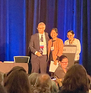 Jungmee Lee receives her fellowship certificate and pin.