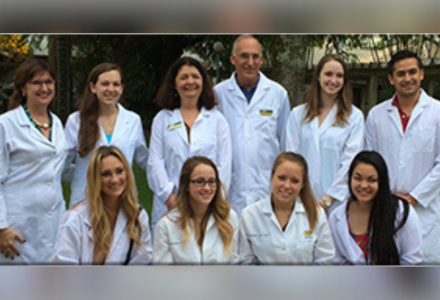 group of faculty and students wearing white coats