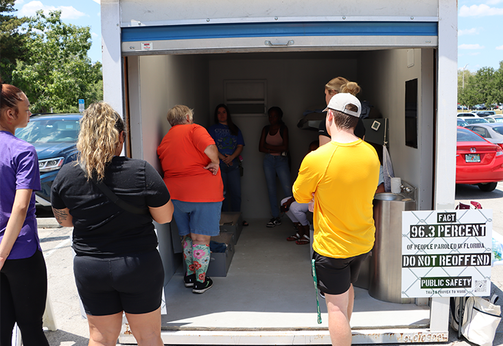 Students look inside the model prison cell