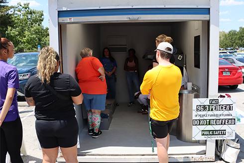 Students look inside the model prison cell