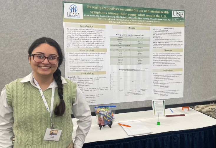 Zena Rodill stands in front of her poster presentation