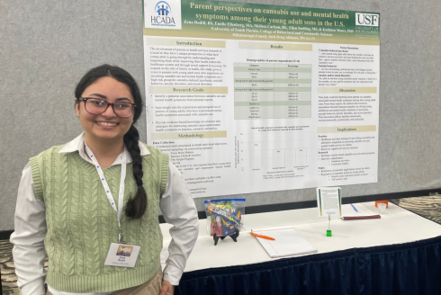 Zena Rodill stands in front of her poster presentation