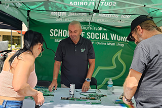 David Kilmnick hands out resources at the School of Social Work booth.