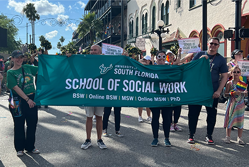 USF School of Social Work representatives walk in the parade