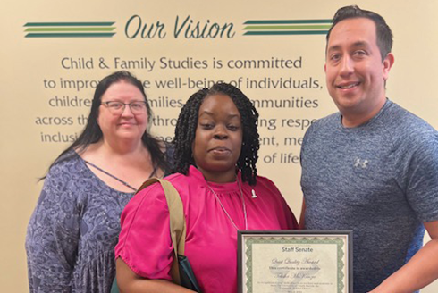 CFS team members Janet Reyes, Telisha McKenzie (award recipient), and David Longa