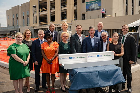 Leadership sign the beam at topping off celebration.