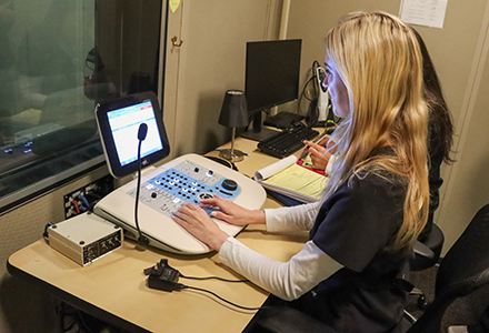 A student conducts a test in the USF Hearing Clinic.