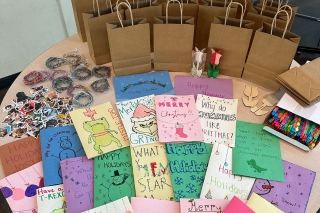 Holiday cards and goodie bags aligned on a table