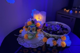 A bowl filled with Halloween candy for students to grab and Calavera on the table 