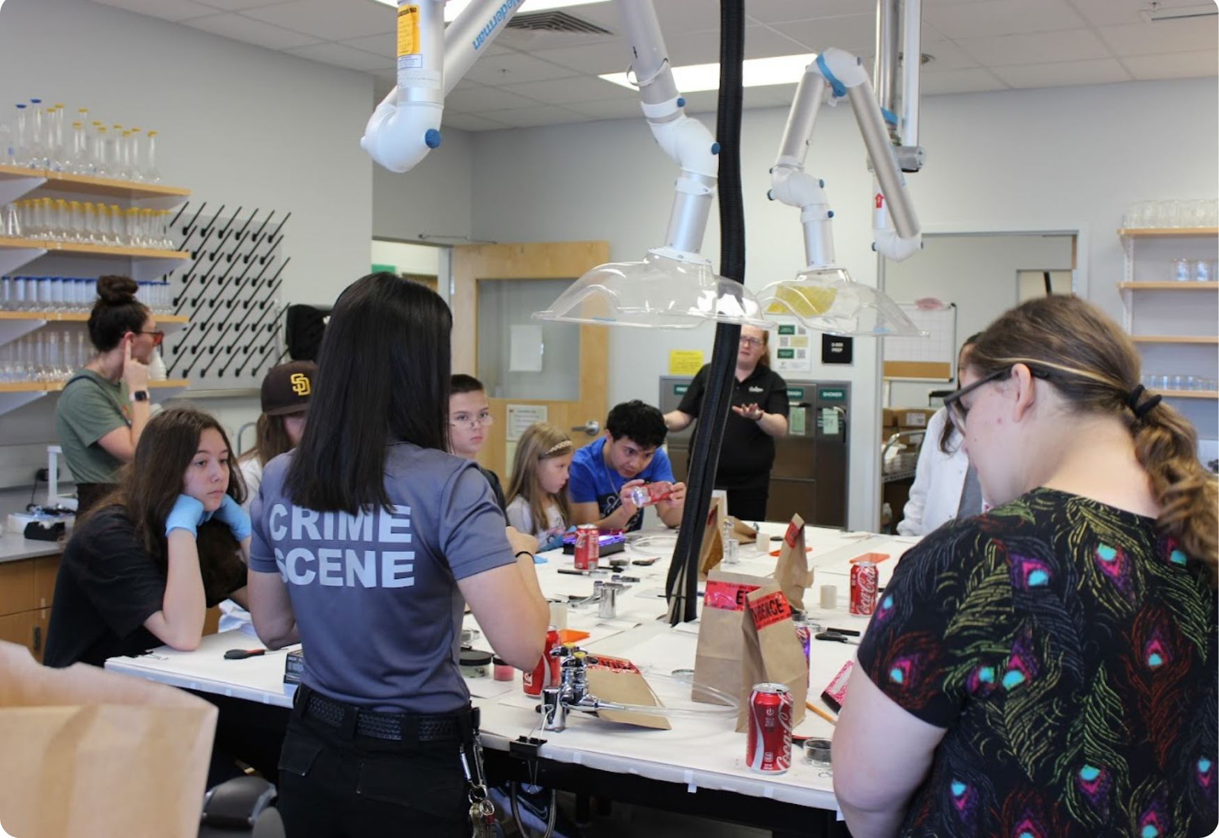 Staff providing guidance to students during a crime scene scenario exercise