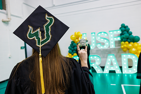 Student in a graduation cap facing away from camera