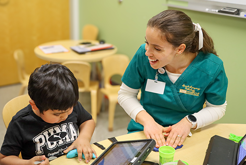 Speech-language pathology student works with patient