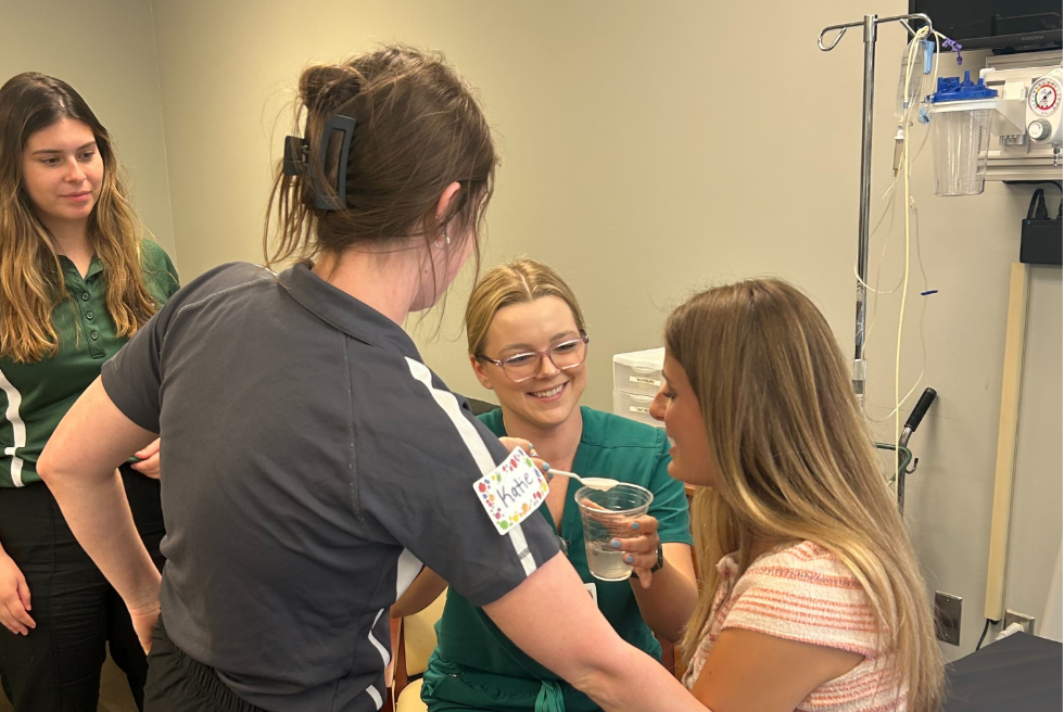 A group of students participating in a hands-on clinical training exercise.