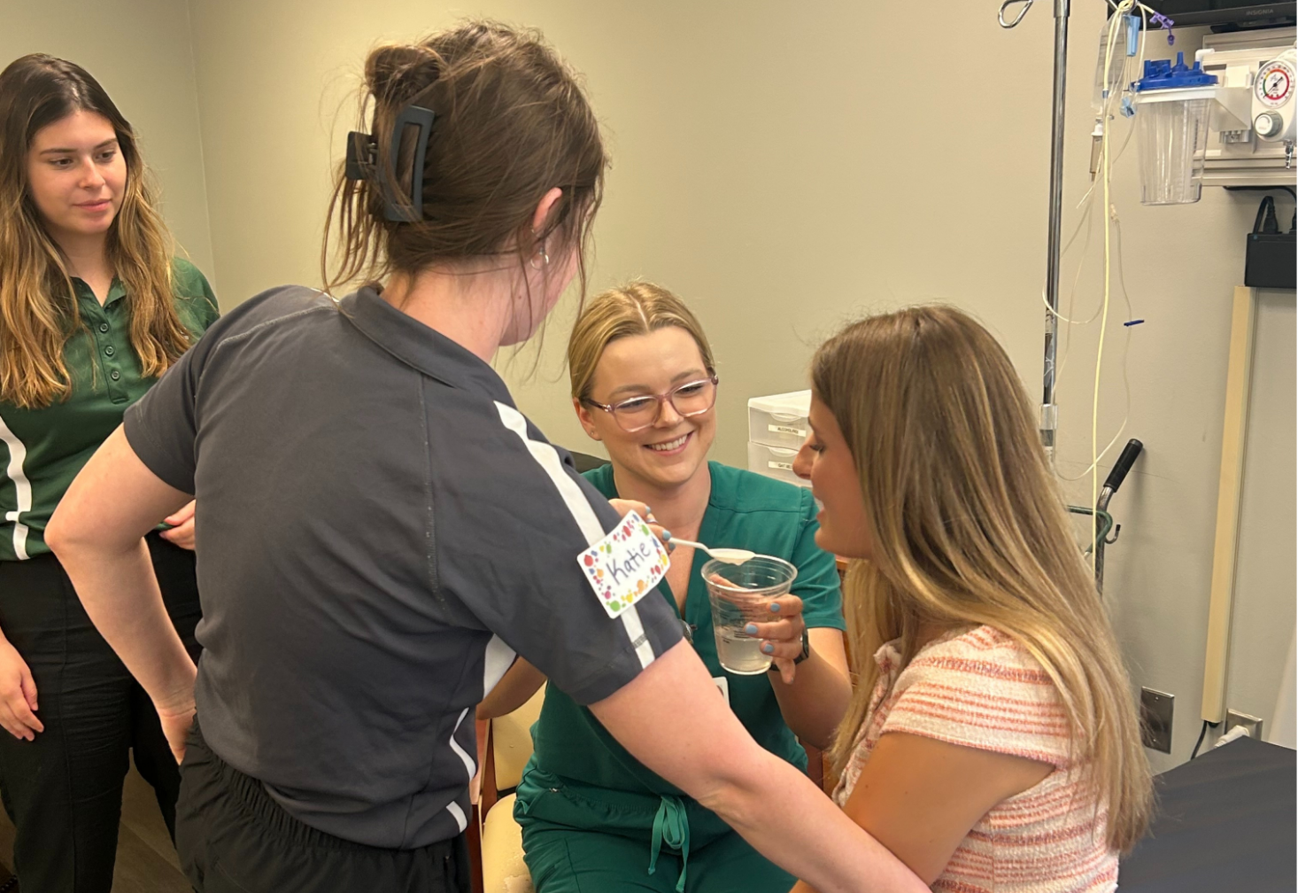 A group of students participating in a hands-on clinical training exercise.