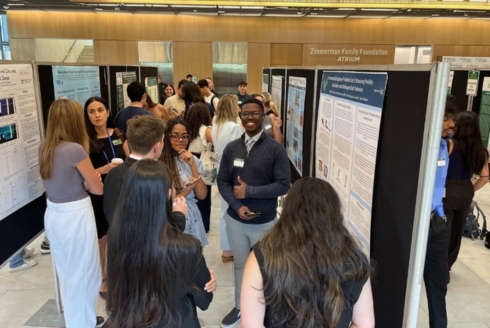 Wide shot of students at the OneUSF Summer Undergraduate Research Symposium 