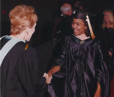 Ercilia Calcano shaking hands with then USF President Betty Castor