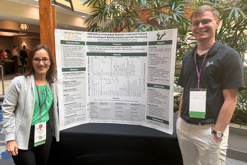 Catia&nbsp;Cividini-Motta and Zachary Crutchfield with their poster
