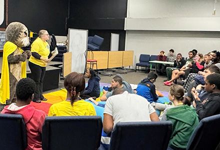 Josh the Otter and Christina Spencer read to a group of students at Florida Autism Center of Excellence.