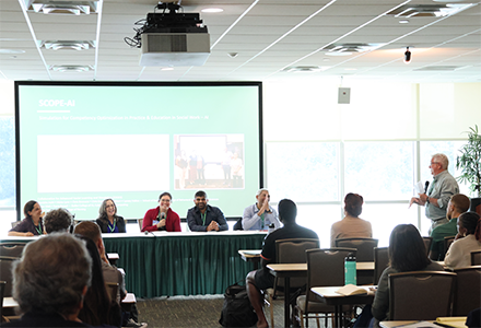 a row of faculty at a panel