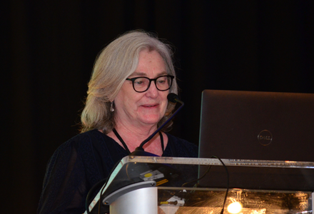 Lise Fox speaks at podium