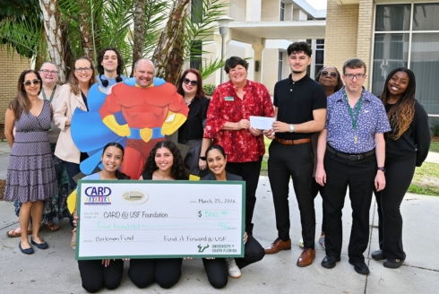 Fund it Foward's executive board members present 500 dollar check to the staff at CARD-USF.