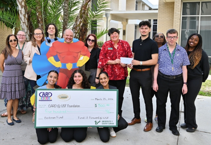 Fund it Foward's executive board members present 500 dollar check to the staff at CARD-USF.