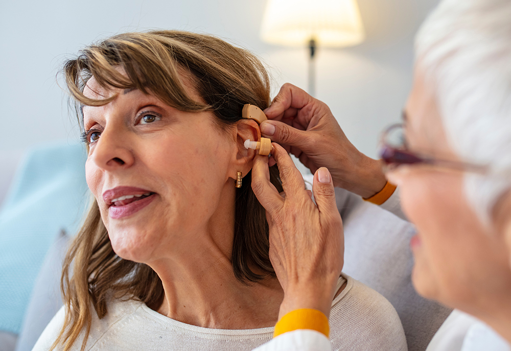 Woman is fitted for a hearing aid
