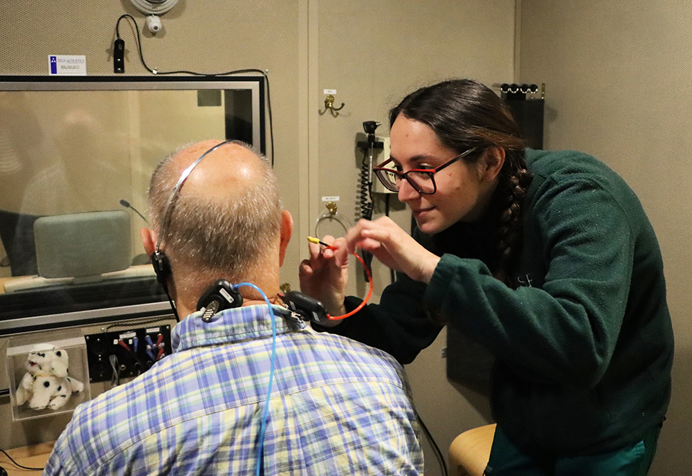 A student conducts a hearing exam