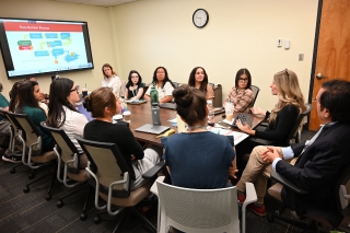 Graduate scholars in a conference room 