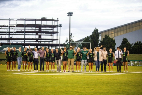 Professors take a group photo at the lacrosse game