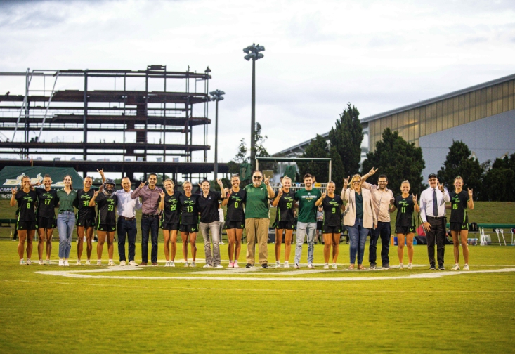 Professors take a group photo at the lacrosse game