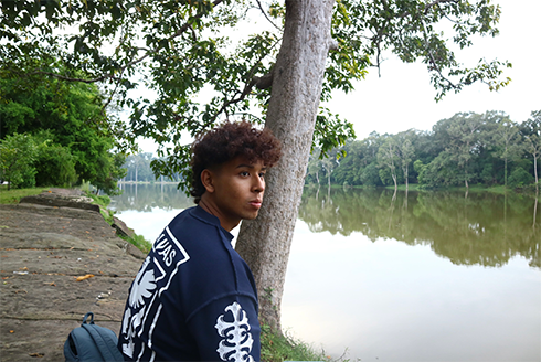 Rithy Rung Rith sitting by a body of water