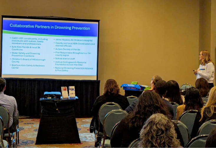 Christine Rover presenting to an audience with a presentation slide on the screen