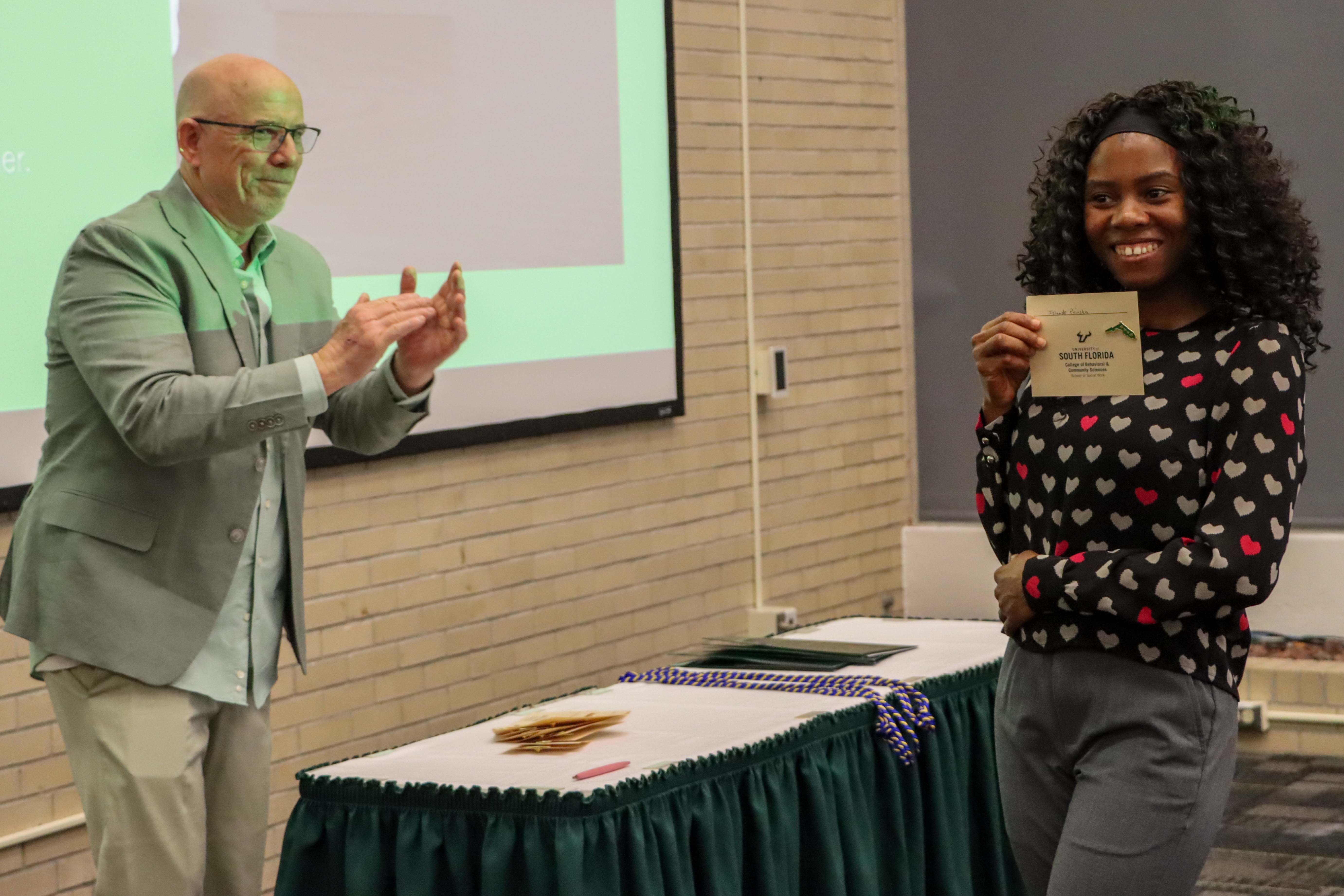 A student is awarded her pin