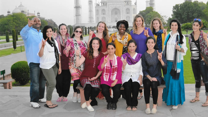 Group of people standing in front of Taj Mahal.