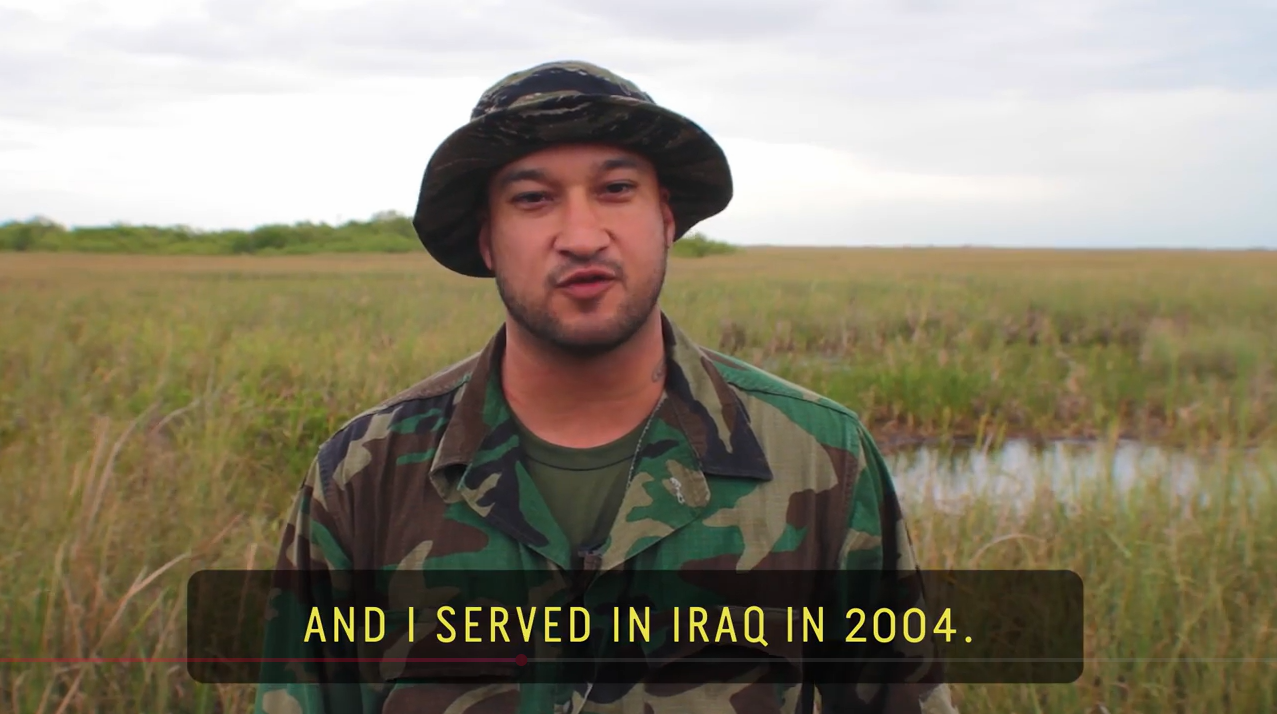 Man wearing camouflage clothes and round hat with Everglades in the background. Caption at the bottom states: "And I served in Iraq in 2004"