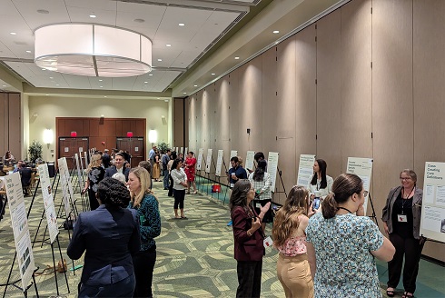 People looking at posters at 2023 Celebration of Teaching
