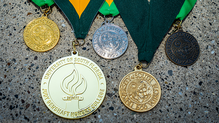 Judy Genshaft Honors College medallion lying on a table