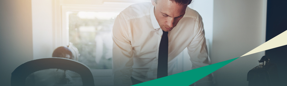 A man in a shirt and tie working on his Paralegal certificate.