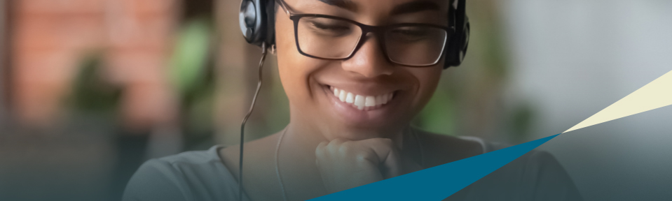 A female educator wearing glasses and a headset.