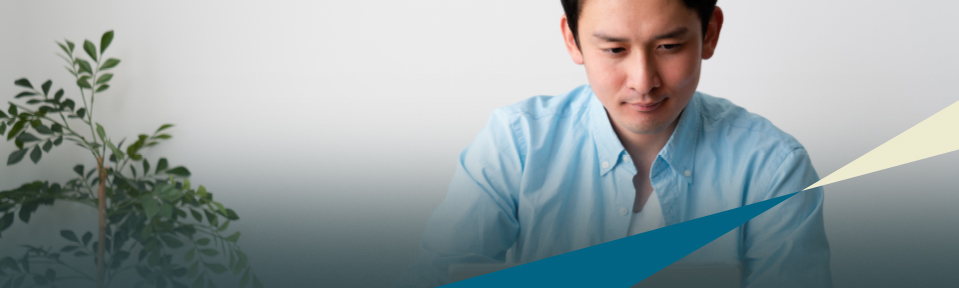 A male teacher in a blue shirt taking the Teacher Certification Exams Preparation course.
