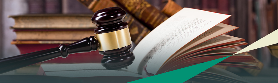 Gavel sitting on top of an open paralegal specialty certificate book.