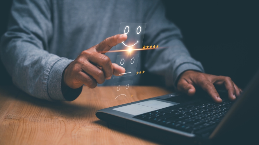Man at laptop rating their employee satisfaction
