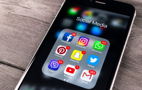 A smartphone with the Social Media apps folder open