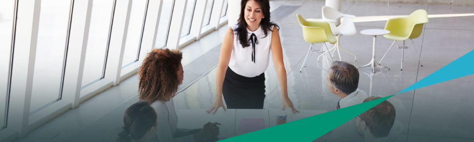 A woman talking in a meeting about the importance of corporate training