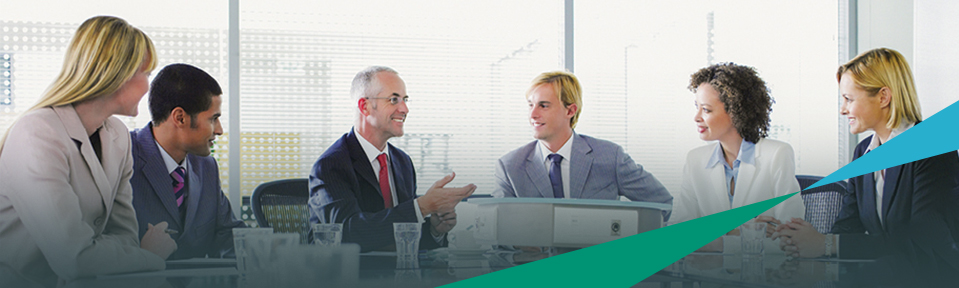 Employees sitting around a conference table during a meeting.